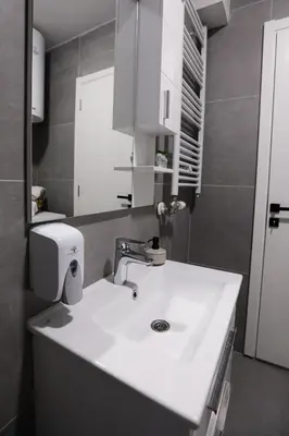 a bathroom with a white sink and a mirror at Apartman Ana in Banja Luka
