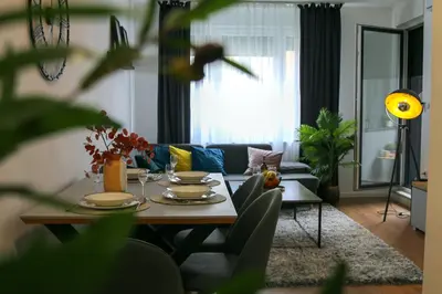 a living room with a table and a couch at Apartman Ana in Banja Luka