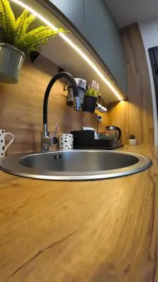 a sink in a kitchen with a wooden counter at Apartman Ana in Banja Luka