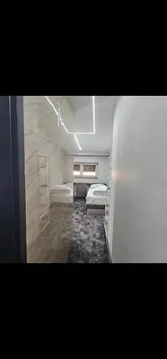 a room with a bedroom with a bed and a ladder at Luxury Room 's in Velika Kladuša