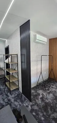 a room with a black book shelf and a spotlight at Luxury Room 's in Velika Kladuša