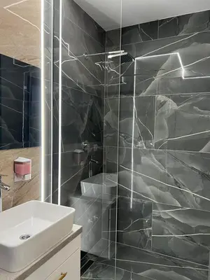 a bathroom with a white sink and a shower at Luxury Room 's in Velika Kladuša