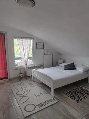 a bedroom with a white bed and a window at Holiday Home Casa Rondo in Bihać