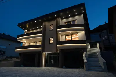 a large building with lights on it at night at SM Exclusive Apartments in Visoko