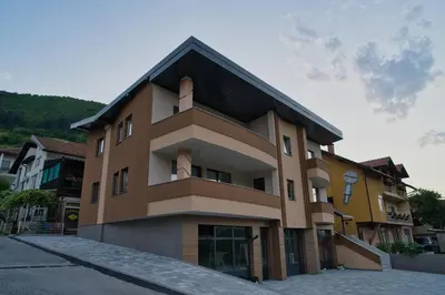 a brown building with a black roof at SM Exclusive Apartments in Visoko
