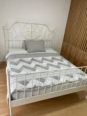 a white bed with a gray pillow on it at Elegance Self check-in Free Parking in Tuzla