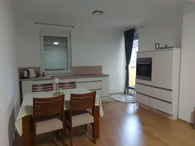 a kitchen with a table and two chairs and a table and a kitchen with at Good Vibes in Bihać