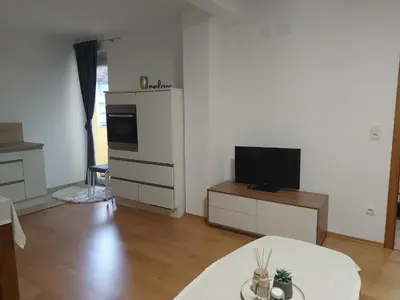 a living room with a television and a table at Good Vibes in Bihać