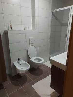 a white bathroom with a toilet and a sink at Good Vibes in Bihać
