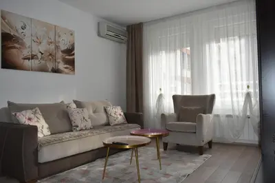 a living room with a couch and a chair at MLK Diamond Apartments in Starčevica