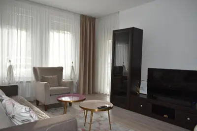a living room with a couch and a tv at MLK Diamond Apartments in Starčevica