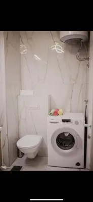 a bathroom with a washing machine and a toilet at Luxury Apartment in Lukavac