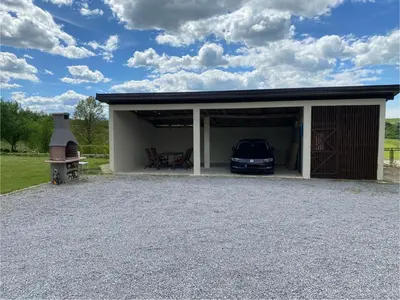 a garage with a car parked inside of it at Kuća za odmor Tarik in Cazin