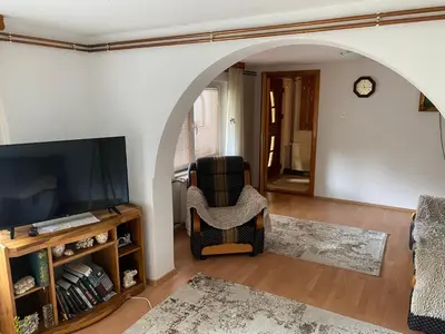 a living room with a chair and a flat screen tv at Kuća za odmor Tarik in Cazin