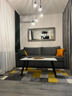 a living room with a couch and a mirror at Apartman 10 in Banja Luka