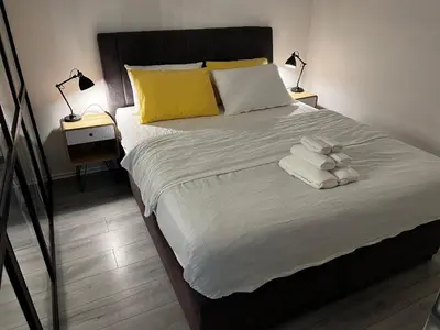 a bedroom with a large bed with towels on it at Apartman 10 in Banja Luka