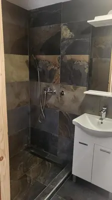 a bathroom with a shower and a sink at Holiday home with private pool ''Lux Banja Luka'' in Banja Luka