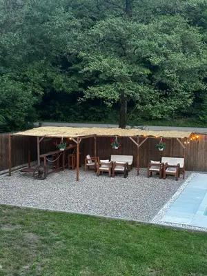 a patio with a table and benches and a tent at Holiday home with private pool ''Lux Banja Luka'' in Banja Luka
