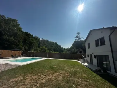 a backyard with a pool and a house at Holiday home with private pool ''Lux Banja Luka'' in Banja Luka