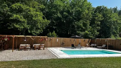 a swimming pool with a table and chairs and a fence at Holiday home with private pool ''Lux Banja Luka'' in Banja Luka