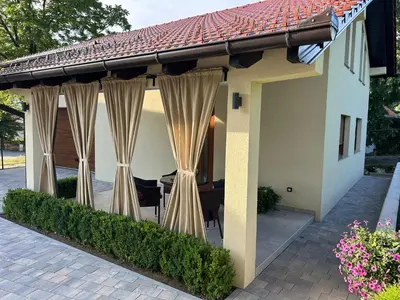 a house with curtains on a patio at Apartman Marin in Livno