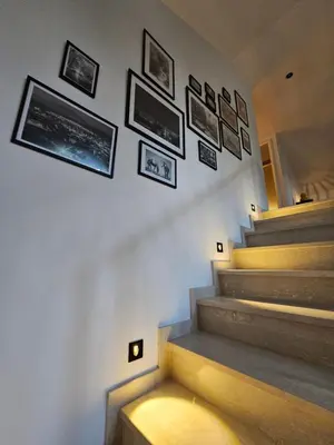 a stairway with pictures on the wall and a stair case at Apartman Marin in Livno