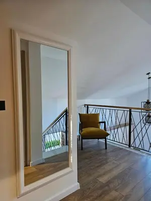 a mirror in a room with a chair on a balcony at Apartman Marin in Livno
