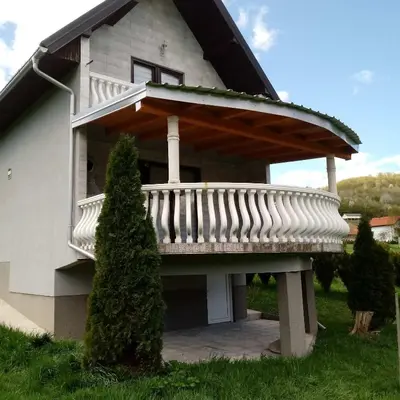 a house with a deck on top of it at Vikendica M&M / Vacation home M&M in Visoko