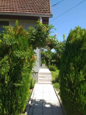 a path leading to a house with some bushes at Vikendica M&M / Vacation home M&M in Visoko