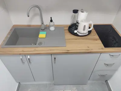 a kitchen with a sink and a counter top at Apartman UMA in Bihać