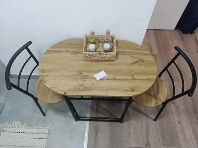 a wooden table with a basket of vases on it at Apartman UMA in Bihać