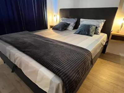 a large bed with two pillows on top of it at Apartman Ena Fojnica in Fojnica