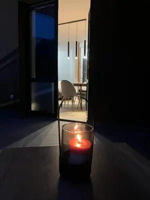 a candle sitting on a table in a dark room at Apartman Ena Fojnica in Fojnica