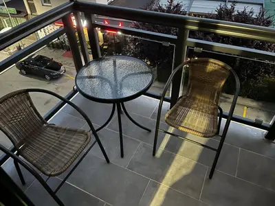 a table and two chairs on a balcony at Apartman Ena Fojnica in Fojnica