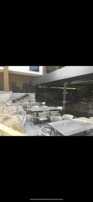 a group of tables and chairs in a building at Apartman Ena Fojnica in Fojnica