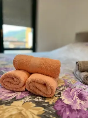 a pile of towels sitting on top of a bed at Apartman Paradise Fojnica in Fojnica