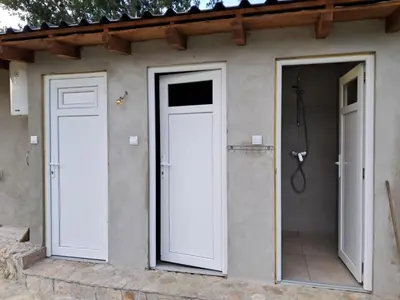 two doors on the side of a house at Auto Camping Grubeša in Dronjići