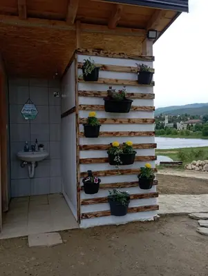 a garden room with potted plants on a wall at Auto Camping Grubeša in Dronjići
