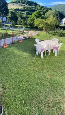 a group of tables and chairs in the grass at Villa Pliva Oasis in Jezero