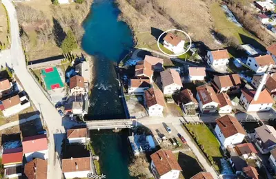 an aerial view of a city with houses and a river at Villa Pliva Oasis in Jezero
