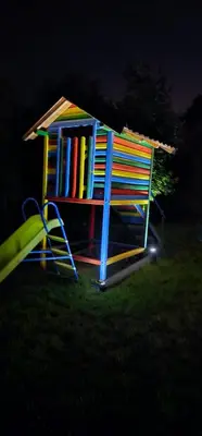 a colorful play house with a slide in the grass at Villa Park Banja Luka in Banja Luka
