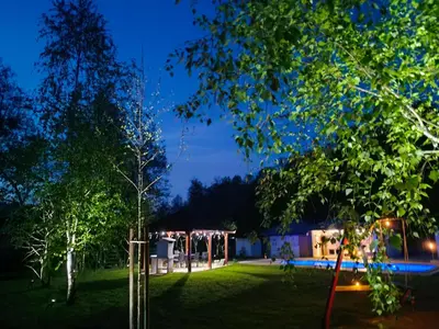 a garden at night with a tent and a pool at Villa Park Banja Luka in Banja Luka