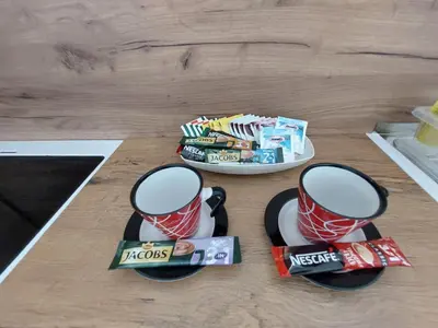a table with two cups and a plate of candy at Apartman 