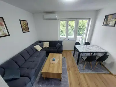 a living room with a couch and a table at Apartman 