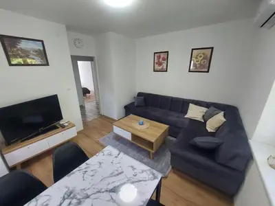 a living room with a couch and a table at Apartman 
