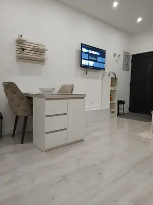 a room with a desk and a tv on a wall at Apartman DANA in Banja Luka