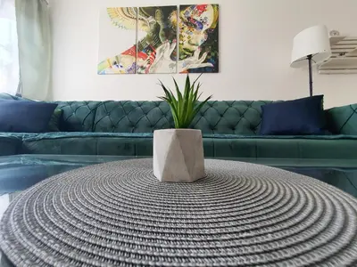 a round table in a living room with a couch at Apartman DANA in Banja Luka