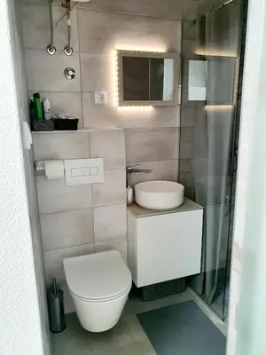 a small bathroom with a toilet and a sink at Apartman DANA in Banja Luka