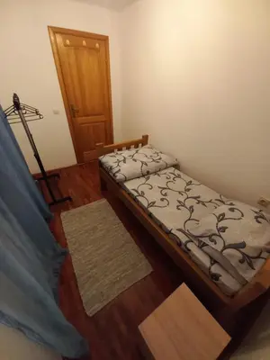 a bedroom with a bed and a wooden floor at Vikendica Savić in Šipovo