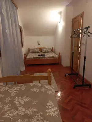 a bedroom with a bed and a table in a room at Vikendica Savić in Šipovo